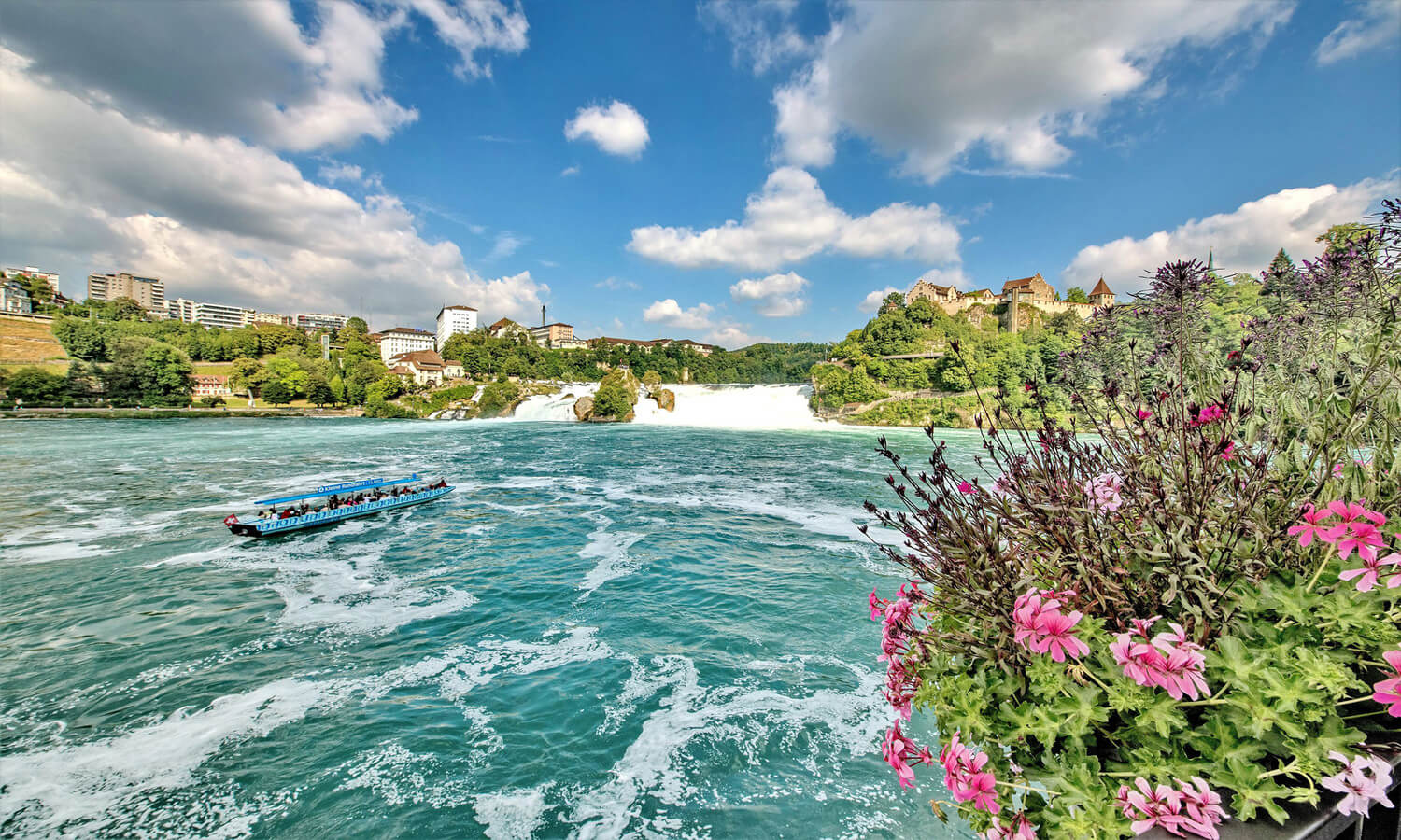 Boat cruise approaching the rock in the middle of Rhine Falls