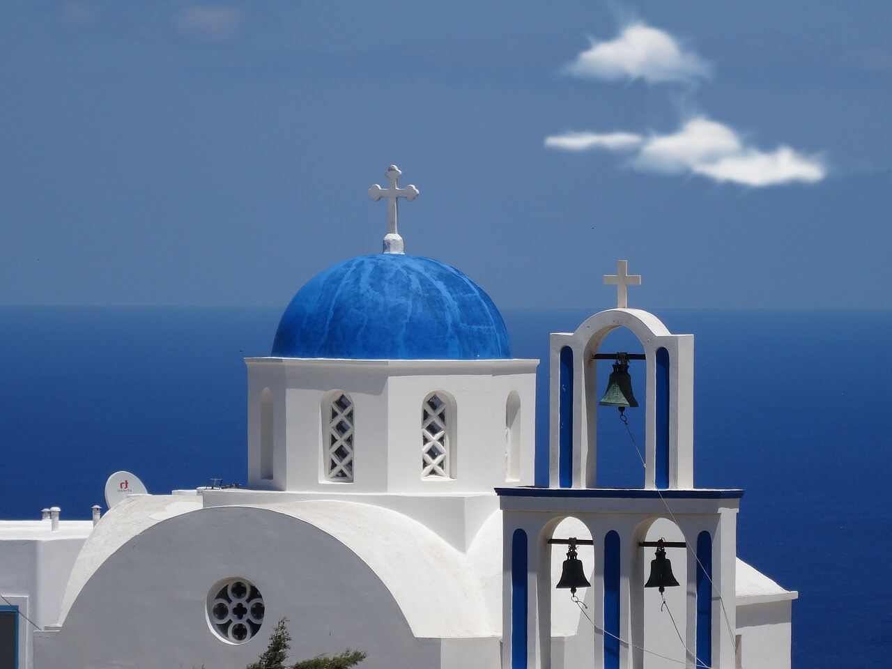 Santorini island iconic blue domes whitewashed buildings Greece